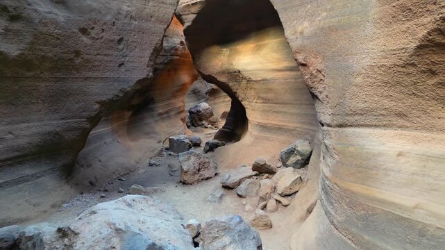 POV shot walking inside the narrow canyon of Barranco de Las Vacas in Gran Canaria. Famous volcanic rock formation with stunning geology