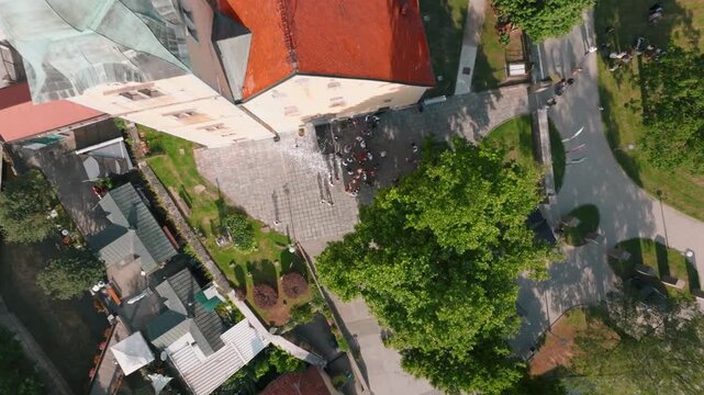 Aerial view of the historic Kurija Hamor building with its red roof, surrounded by lush trees and paved courtyard in the town of Samobor, Zagrebacka zupanija, Croatia.