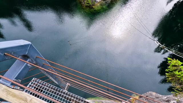 Quarry lake reflecting forest and cliffs.