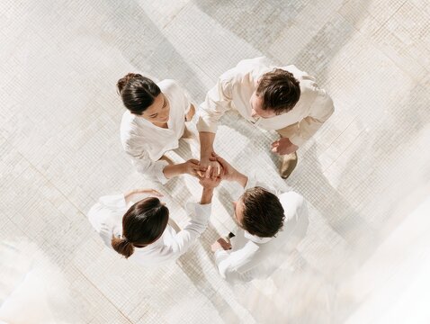 Business team putting hands together in a huddle