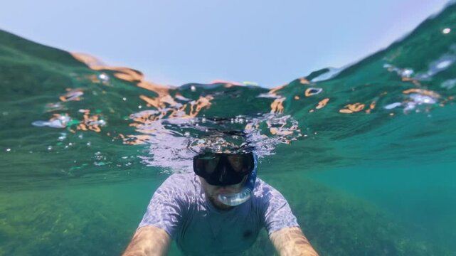 Man Snorkeling in Clear Turquoise Sea Water Split View