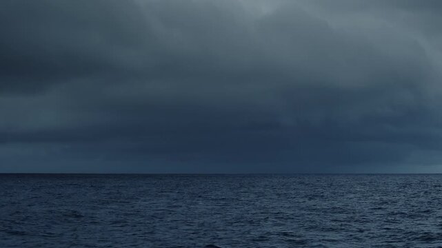 Dark Atlantic Ocean and stormy clouds as seen from the moving sailing boat
