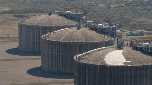 Aerial view of the Dunkirk LNG Terminal featuring large industrial storage tanks surrounded by coastal landscape in Loon-Plage, Hauts-de-France, France.