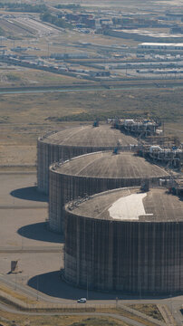 Aerial view of the Dunkirk LNG Terminal featuring large storage tanks, industrial infrastructure, and surrounding coastal landscape in Loon-Plage, Hauts-de-France, France.