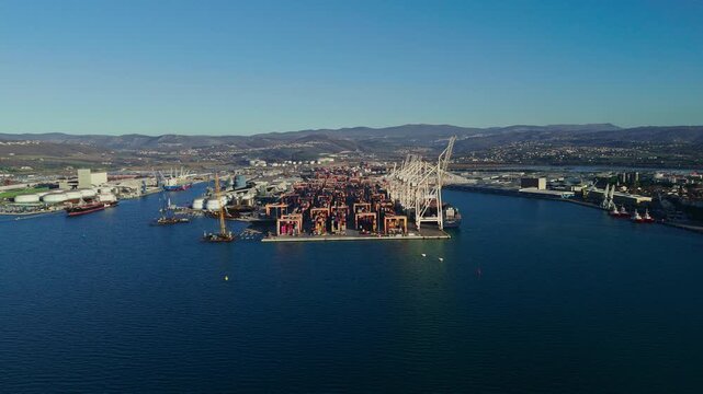 Koper features a bustling waterfront, historic buildings, and a busy marina on the Adriatic Sea. The landscape displays Mediterranean charm.