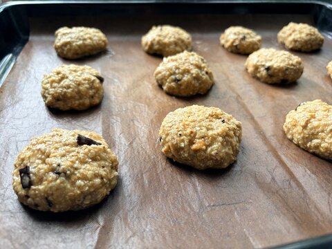 oatmeal cookie dough spread out on a baking sheet