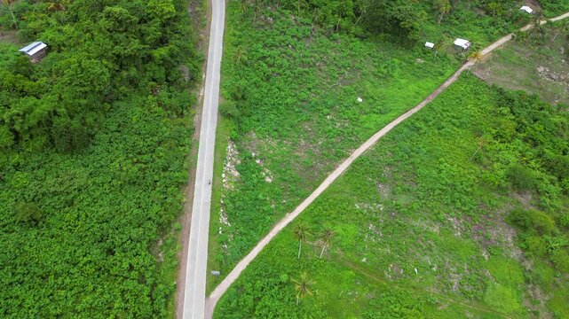 Scooter Travels Along Straight Road Samal Island Tropical Mindanao Philippines Drone Birdseye 4K 30FPS