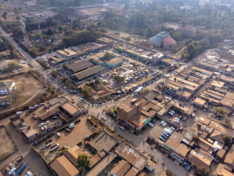 Aerial view of the bustling marketplace with rows of shops, busy streets, and a circular building in Loitokitok, Kajiado County, Kenya.