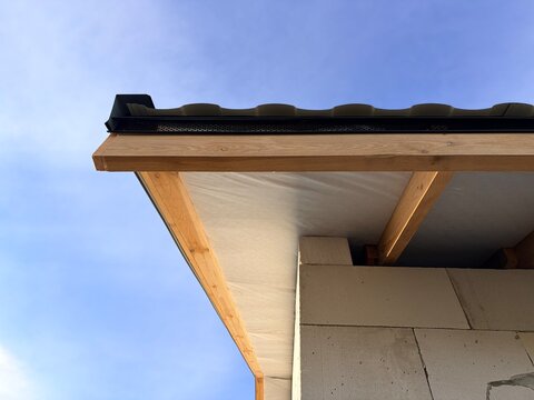 A house roof under construction featuring wooden fascia. Concepts of home building, roofing installation