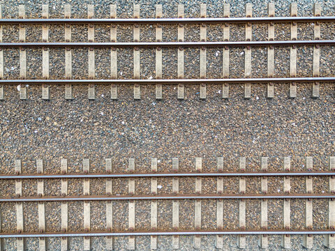 Aerial view of parallel railway tracks with concrete sleepers and gravel ballast in Santahar Pouroshova, Rajshahi Division, Bangladesh.