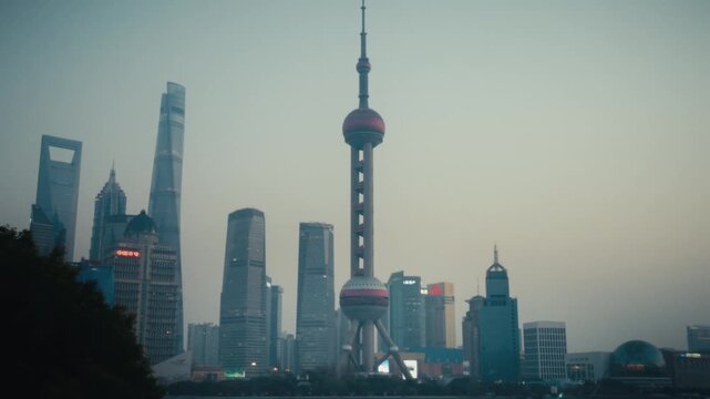 The Pudong skyline in Shanghai is bathed in twilight haze, with the Oriental Pearl Tower, Shanghai World Financial Center, and Jin Mao Tower forming a dramatic silhouette against the evening sky.