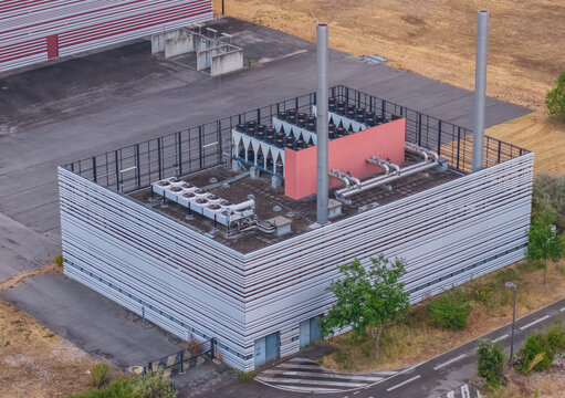 Aerial view of industrial cooling infrastructure featuring rooftop dry coolers, HVAC systems, heat exchangers and mechanical piping in Valence, Auvergne-Rhone-Alpes, France.