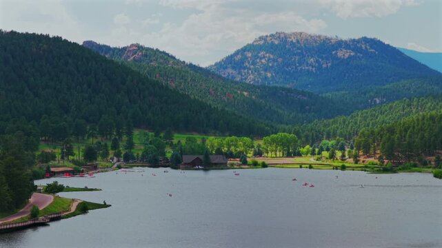 Evergreen Lake House aerial drone Evergreen Colorado foothills Denver Golf Course paddleboarding canoe boats Upper Bear Creek Front Range Rocky Mountain summer spring sunny cloudy morning circle left