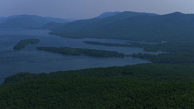 Islands of Lake George New York State aerial drone view nature landscape spring summer July sunny boating swimming recreation water activities morning blue sky Adirondack Mountains backwards pan up