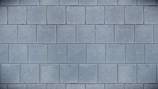Gray concrete paving stones form a seamless loop texture background.