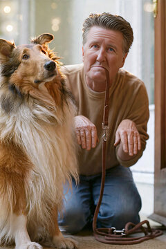 Funny staged photo of middle-aged man kneeling holding brown leather dog leash in mouth begging for walk, role reversal with rough collie sitting beside him, man imitating dog behavior in home doorway