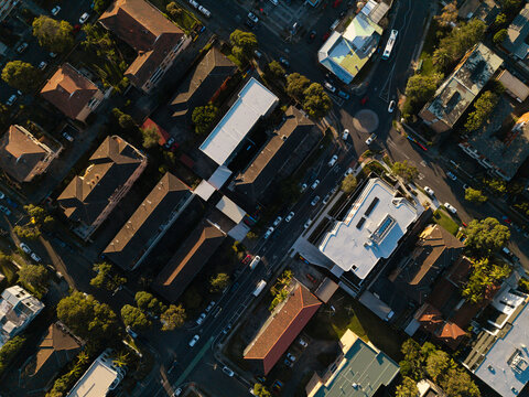 Aerial view of residential streets and buildings in the Northern Beaches area with lush trees and parked cars, Northern Beaches, New South Wales, Australia.