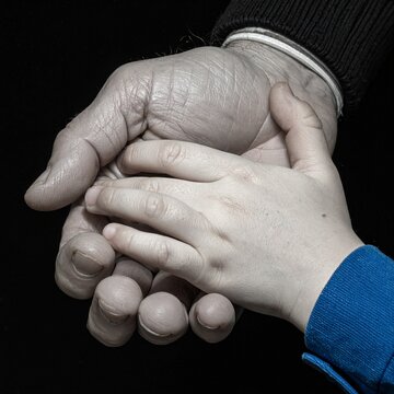 Two Hands Hold Each Other Intergenerational Support Safe