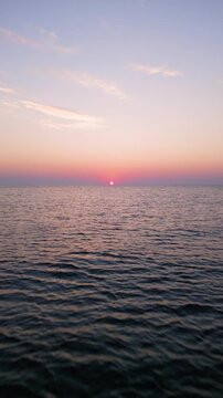High Aerial View of Golden Sunrise Sunset Over Open Sea Water Horizon