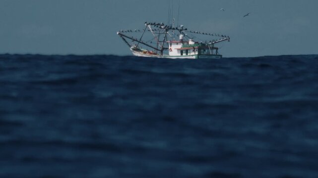 Fishing boat moves in the Atlantic Ocean near the Brazilian shore