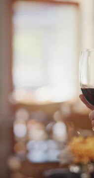 People, hands and red wine with cheers in restaurant for romantic dinner, date or fine dining. Glasses, man and woman with toast or love in diner for romance, celebration or anniversary together