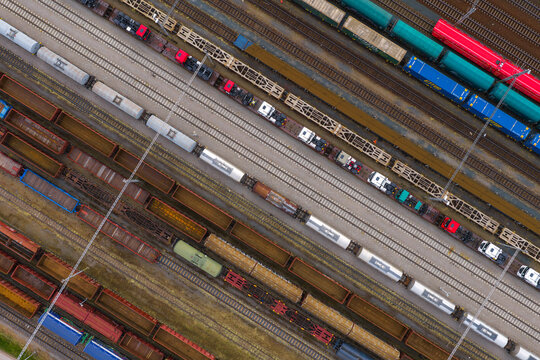 Aerial view of freight trains parked on parallel railway tracks at a large marshalling yard in Breclav, South Moravian Region, Czechia.