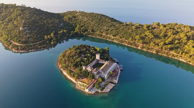 Saint Mary Island monastery surrounded by turquoise lake waters on Mljet, aerial view of famous Croatian landmark. Picturesque Saint Mary Island in the middle of Great Lake on Mljet, Croatia 