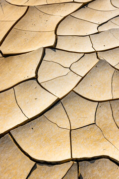 Aerial view of the cracked dry earth patterns of the Tuzbair salt flats in the desert landscape, Mangystau District, Mangystau Region, Kazakhstan.