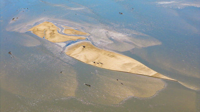 Aerial view of a riverbed with low water levels and exposed sandbanks in shallow water in Poland.