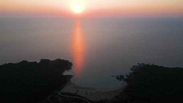 Drone Flying Forward Over Silistar Beach Bay at Golden Sunrise Sunset