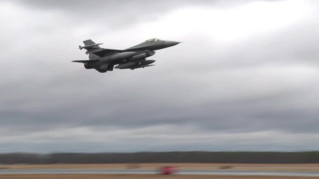 An F-16 Fighting Falcon fighter jet takes off from the runway of an Air Force base