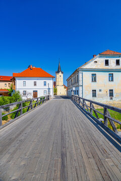 Old wooden bridge over Krka river in town Kostanjevica na Krki in Slovenia.