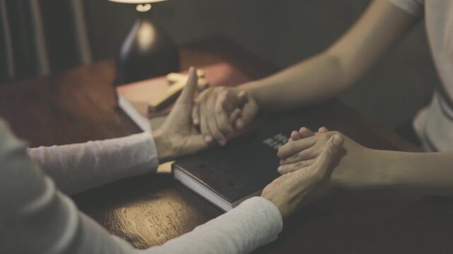 Two people joining hands in prayer, seeking God with faith and hope, symbolizing love, trust, care, and spiritual support.