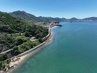 Obraz premium Yosan Line Running Along the Seto Inland Sea Near Kaiganji Temple, Japan