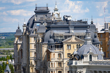 Historic palace rooftop with ornate domes and winged lion statues © Mariia