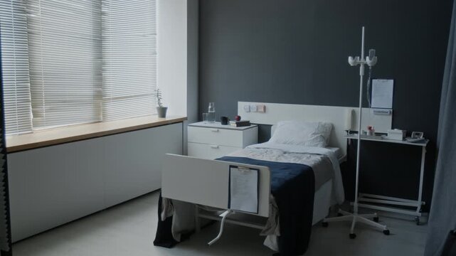 Empty hospital room featuring modern medical bed, IV stand, and bedside table. Clip for healthcare marketing, medical insurance commercials, or clinical facility presentations