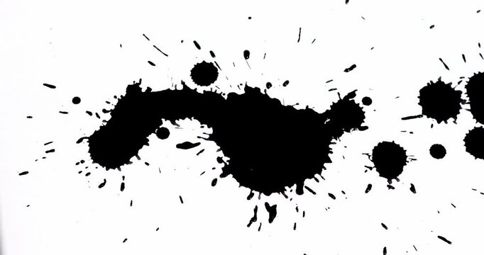 Ink splashes on a white sheet of paper. Black paint stains on a white background.