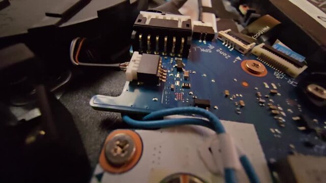 Macro close-up shot of a laptop circuit board, showcasing internal wire connectors and speaker (SPK) plug sockets with intricate electronic components. Ideal for technology, hardware repair