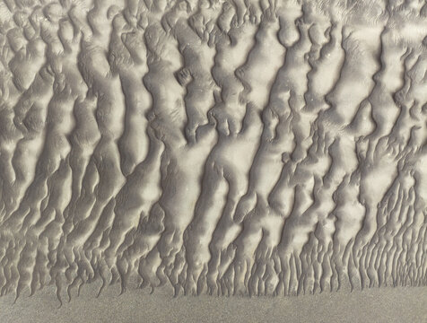Aerial view of the intricate wind-swept sand dunes of the Skeleton Coast in the Kunene Region, Namibia.