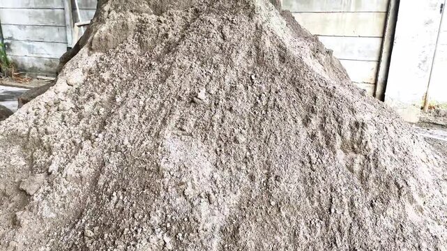 A pile of ash or sand remaining from coal combustion, or called 'Bottom Ash', is isolated on a transparent background. 