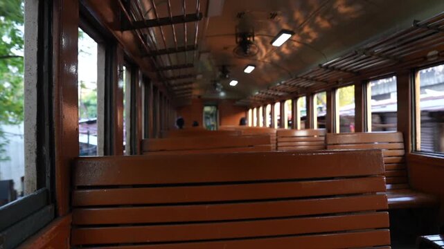 Empty wooden benches inside moving vintage train