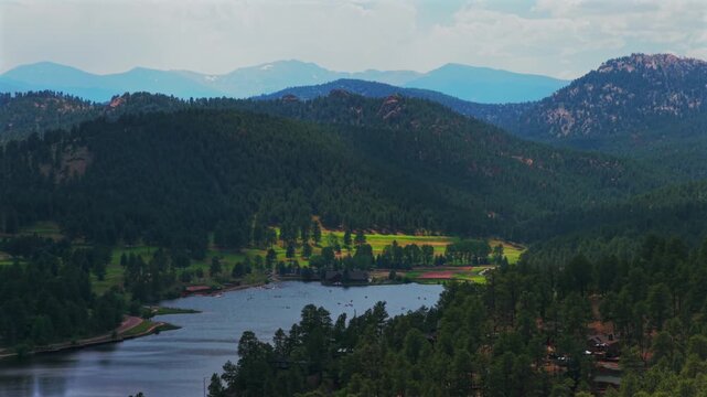 Evergreen Lake aerial drone view Evergreen Colorado foothills Denver Golf Course Mt Blue Sky Front Range Rocky Mountain summer spring sunny cloudy morning paddleboarding circle right parallax motion