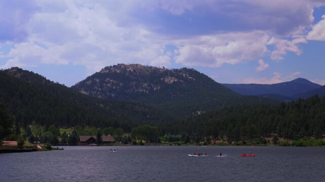 Summer Evergreen Lake water sports aerial drone Evergreen Colorado foothills Denver Golf Course paddleboarding canoe kayak boats Front Range Rocky Mountain sunny cloudy morning haze static shot