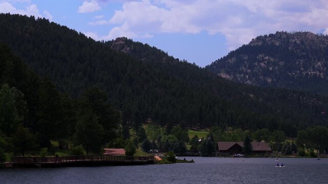 Summer Evergreen Lake walking bridge paddleboarding canoe kayak boats aerial drone Evergreen Colorado foothills Denver Golf Course Front Range Rocky Mountain sunny cloudy morning haze focus static