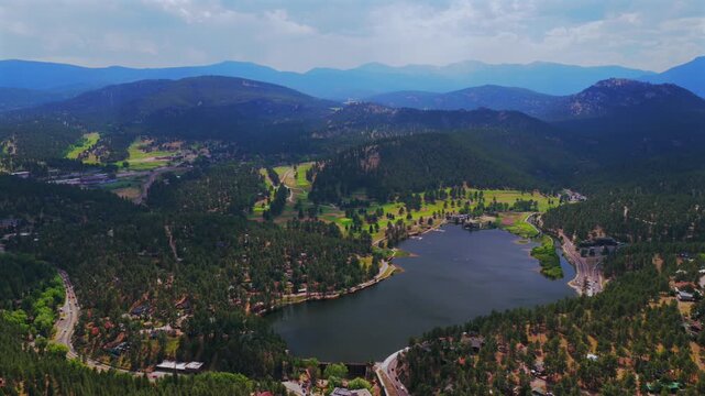 Downtown Evergreen Colorado foothills view Evergreen Lake aerial drone Denver Golf Course Mt Blue Sky Front Range Rocky Mountain summer spring sunny cloudy morning paddleboarding circle left motion