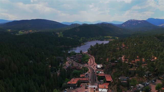 Downtown Evergreen Colorado main street business buildings view Evergreen Lake aerial drone Denver Golf Course Mt Blue Sky Front Range Rocky Mountain summer spring sunny cloudy morning circle left