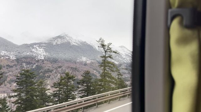 snow-capped French Alps near Modane in Personal perspective from bus window