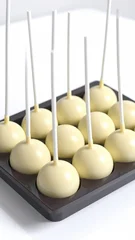 Creamy spheres on sticks, arranged in a dark tray against a white backdrop © Ajinomoto
