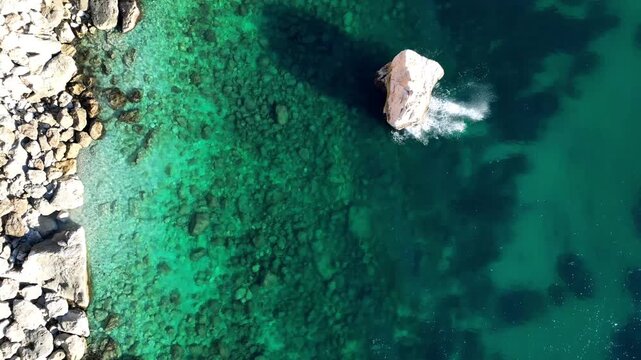 Aerial view of rocky coastline and turquoise sea in Calp, Valencian Community, Spain.
