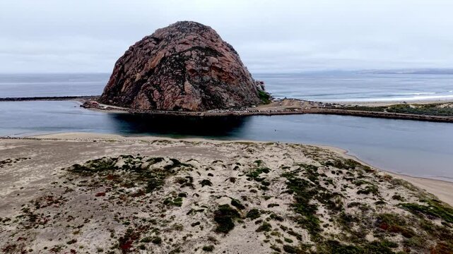 aerial push over the top of morro rock in morro bay california